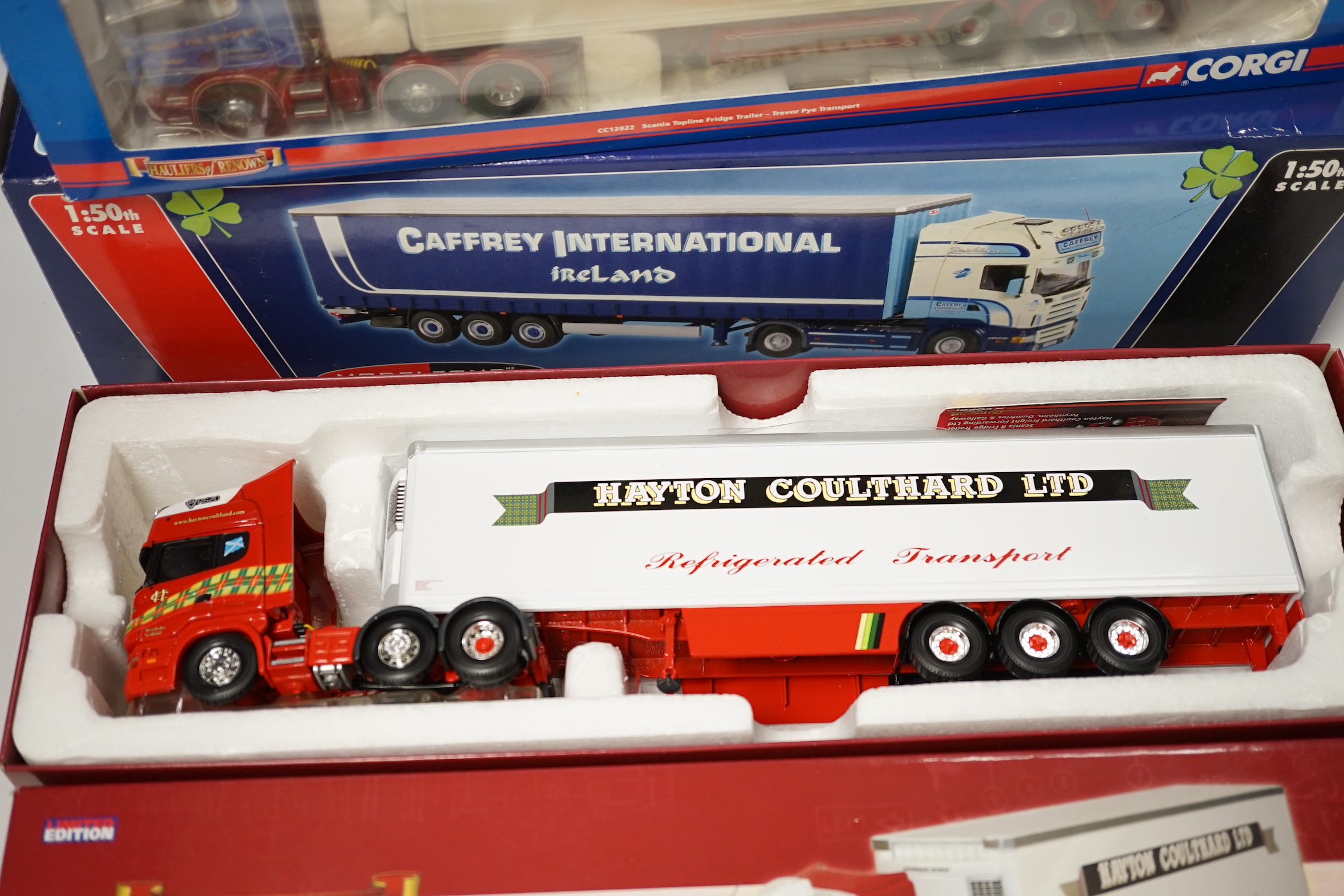 Four boxed Corgi and Universal Hobbies 1:50 scale articulated trucks; a Scania refrigerated lorry (CC13727), Scania Topline refrigerated lorry (CC12922), a Renault Premium Curtainside (75602), and another Scania Topline